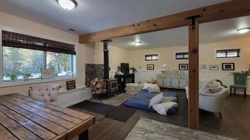 a living room with a wooden table and a couch at Modern Open Concept Mountain View NEW Home in Mount Shasta