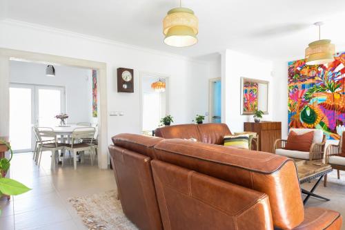 a living room with a couch and a table at Aroeira villa with heated pool by Golf course, Beach and Lisbon in Aroeira