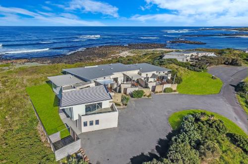 an aerial view of a house with the ocean at Hearns Beachside Villa 9 in Port Fairy