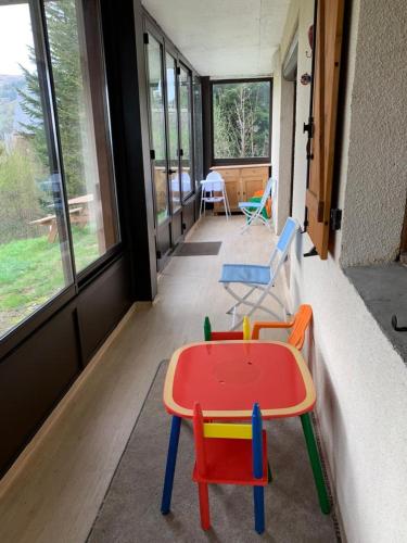 une chambre avec une table et des chaises dans une maison dans l'établissement Chalet- Capacité 8/10 pers au cœur de la station, à Besse-et-Saint-Anastaise