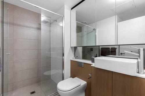 a bathroom with a toilet and a sink and a mirror at Perfect Urban Retreat! in Melbourne