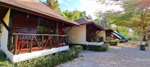 a house with a porch on the side of it at Saithong Resort in Pak Meng