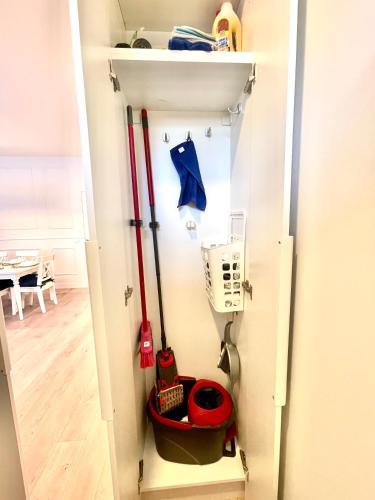 a closet with hockey equipment on a wall at Nida family apartments in Nida