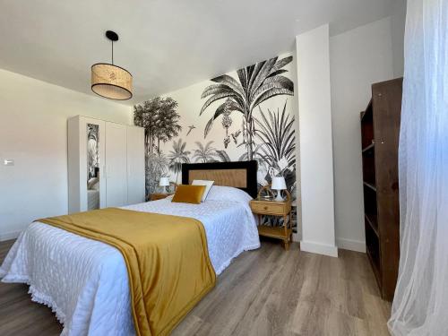 a bedroom with a bed with a yellow blanket on it at Piso familiar cerca de playa in Pobra do Caramiñal
