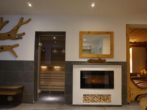 a living room with a fireplace and a mirror at Apartment in Wildschönau by Schatzberg Lift in Auffach