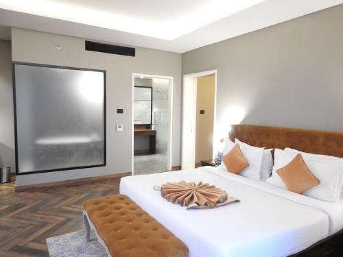 a bedroom with a large bed with a large screen at Hotel Polo Towers Agartala in Agartala