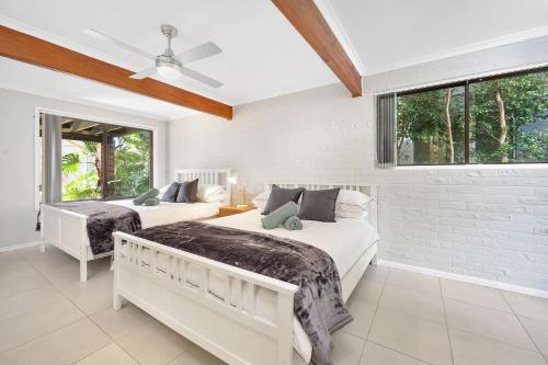 a bedroom with two beds and a window at Fields of Green by Experience Jervis Bay in Vincentia