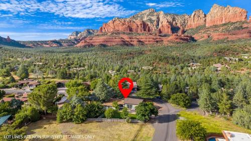 an aerial view of a home with a red marker on it at Sedona Uptown Gem!Large yard w grass and shade trees! Views!! NEW! BARREL SAUNA!!! Close to trails, walk to Uptown Sedona, restaurants and shopping in Sedona