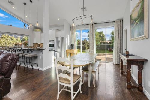 a dining room and kitchen with a table and chairs at Sedona Uptown Gem!Large yard w grass and shade trees! Views!! NEW! BARREL SAUNA!!! Close to trails, walk to Uptown Sedona, restaurants and shopping in Sedona
