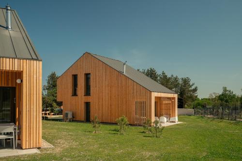 a large wooden barn with a house at Morze Sasino in Sasino