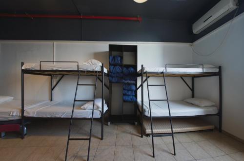 a room with three bunk beds in a room at Tiberias Hostel in Tiberias