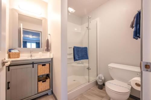 a bathroom with a shower and a toilet and a sink at Lakeside Villa in Penticton