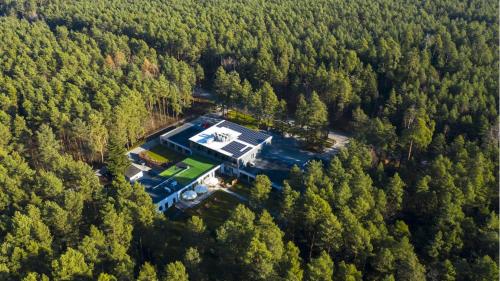 an aerial view of a house in the woods at SZUMY PARK Hotel & Restaurant in Susiec