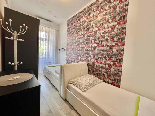 a living room with a couch and a wall at Holiday home in Crikvenica 42922 in Crikvenica