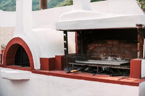a brick oven with a table in it at Greek Style Apartment with Jaquzzi & Barbeque in Triánta