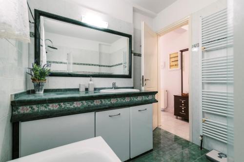 a bathroom with a sink and a mirror at Greek Style Apartment with Jaquzzi & Barbeque in Triánta
