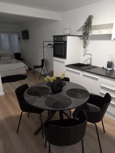 a kitchen with a table and chairs in a room at Velvet in Vinkovci