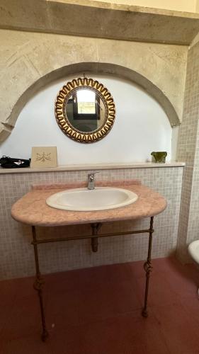 a bathroom sink with a mirror on the wall at La Dimora Del Barone in Vernole