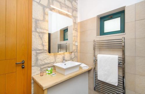 a bathroom with a sink and a mirror at Villa Fegari in Mochlos