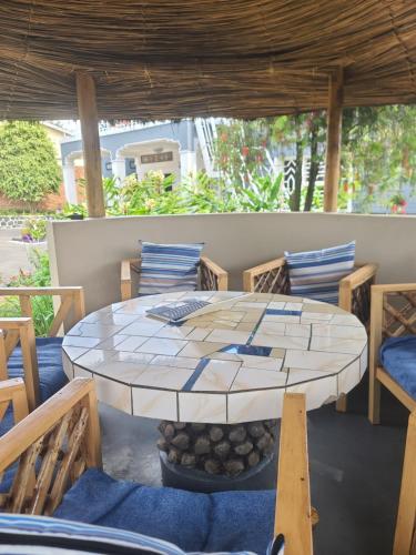 a table and chairs on a patio at Volcano View in Ruhengeri