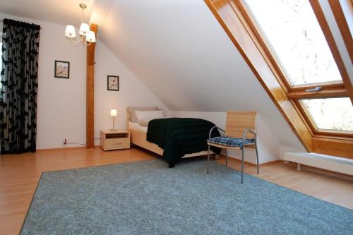 a attic bedroom with a bed and a blue rug at Ferienwohnung Bisch in Görlitz