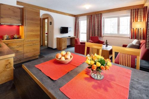 a living room with a table with a bowl of fruit at Appartement Désirée inkl der SUPER SOMMER CARD im SOMMER 2025 in Serfaus