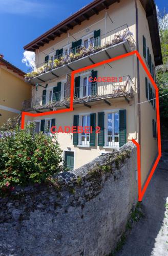 a building with orange paint on the side of it at Cadebei in Oggebbio