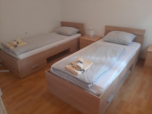 Habitación con 2 camas individuales y suelo de madera. en Holiday Home Nadija, en Brseč