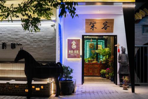 a horse statue in front of a store front at Joke Inn in Xi'an