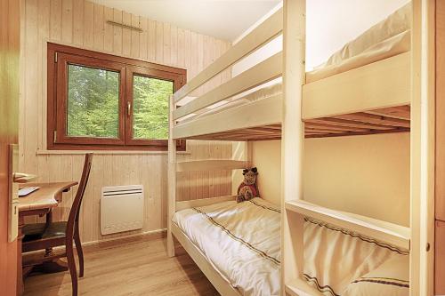 a bedroom with bunk beds and a table and a desk at Le Schwarzwald - A proximité des stations de ski in La Bresse
