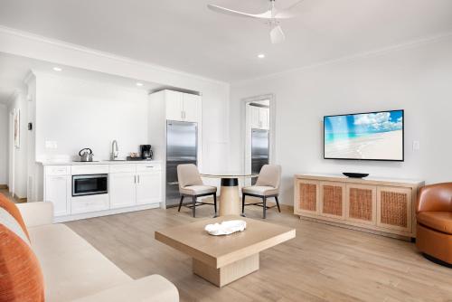 a living room with a couch and a table at Alexandra Resort - All-Inclusive in Grace Bay