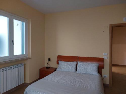 a bedroom with a bed with two pillows and a window at Adagio Ravello in Ravello