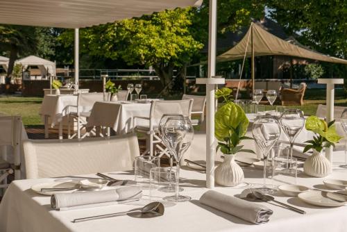 a table with plates and glasses and napkins on it at Villa Abbondanzi Resort in Faenza