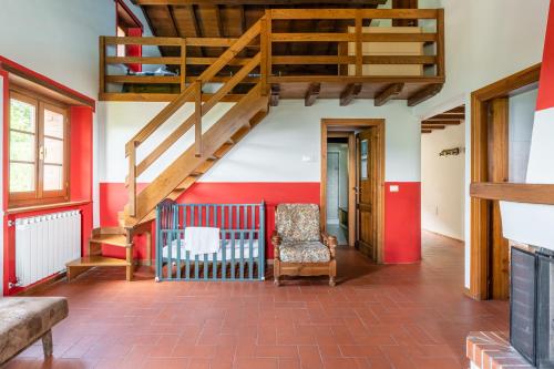 a living room with a staircase and a chair at Il Serrino 5 in Pistoia