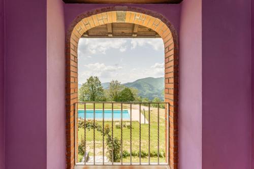 an archway in a building with a view of a pool at Il Serrino 5 in Pistoia