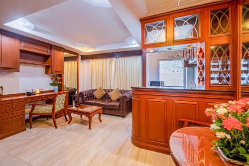 a kitchen and living room with a table and a couch at The Yorkshire Hotel - SHA Certified in Patong Beach