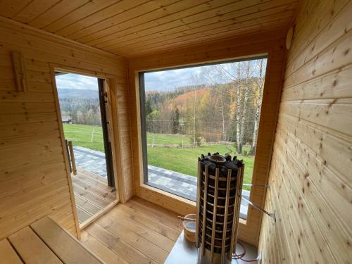 a room with a large window in a wooden cabin at Apartamenty Carpe Diem in Ustroń