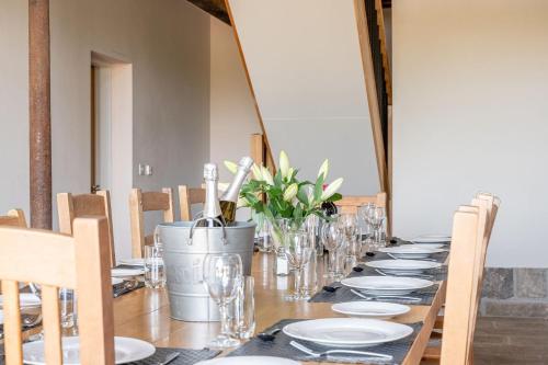 a long table with plates and glasses on it at Meadow Barn in Rishworth