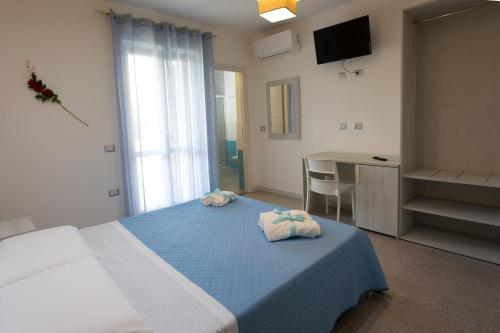A bed or beds in a room at B&B L'Oasi