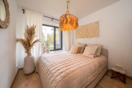 a bedroom with a bed and a large window at Jurmala seaside apartment with balcony in Jūrmala
