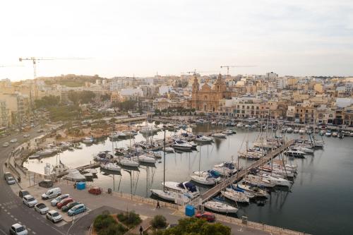 a group of boats docked in a harbor at The Address Seafront Suites with Hot Tub in Pieta