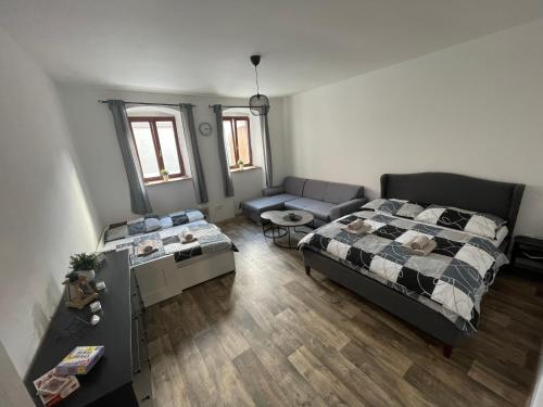 an aerial view of a bedroom with a bed and a couch at Domeček Slavonice in Slavonice