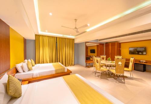 a bedroom with a bed and a dining room at Shamrock Greens by Jardin Hotels in Dharmpura