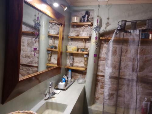 a bathroom with a sink and a mirror at Studio Penelope in Kerasochórion