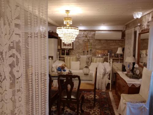 a dining room with a table and a chandelier at Studio Penelope in Kerasochórion