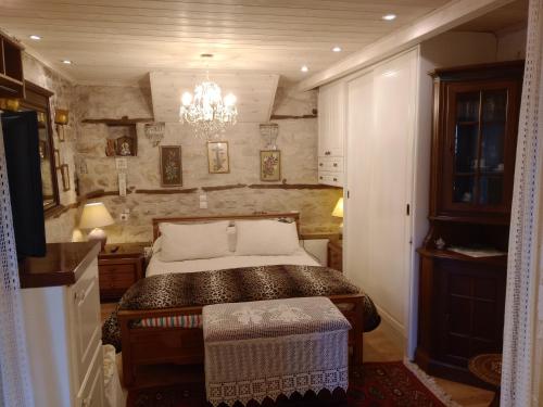 a bedroom with a bed and a chandelier at Studio Penelope in Kerasochórion