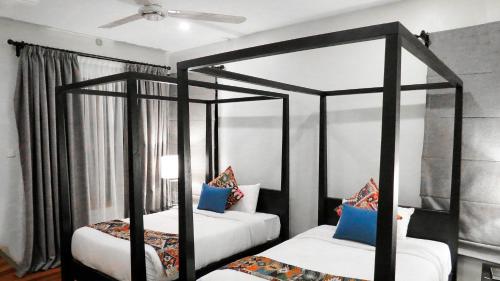 two beds in a room with two canopy beds at Mara Leisure Camp in Talek