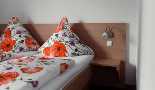 a bed with two pillows on top of it at Steinhägerquelle in Steinhagen
