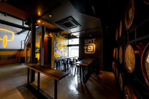a restaurant with wooden tables and chairs in a room at The Villa & Barrel Lounge in Shizuoka
