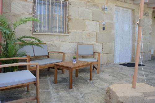 a patio with two chairs and a table at Corte Soleto 22 in Martano